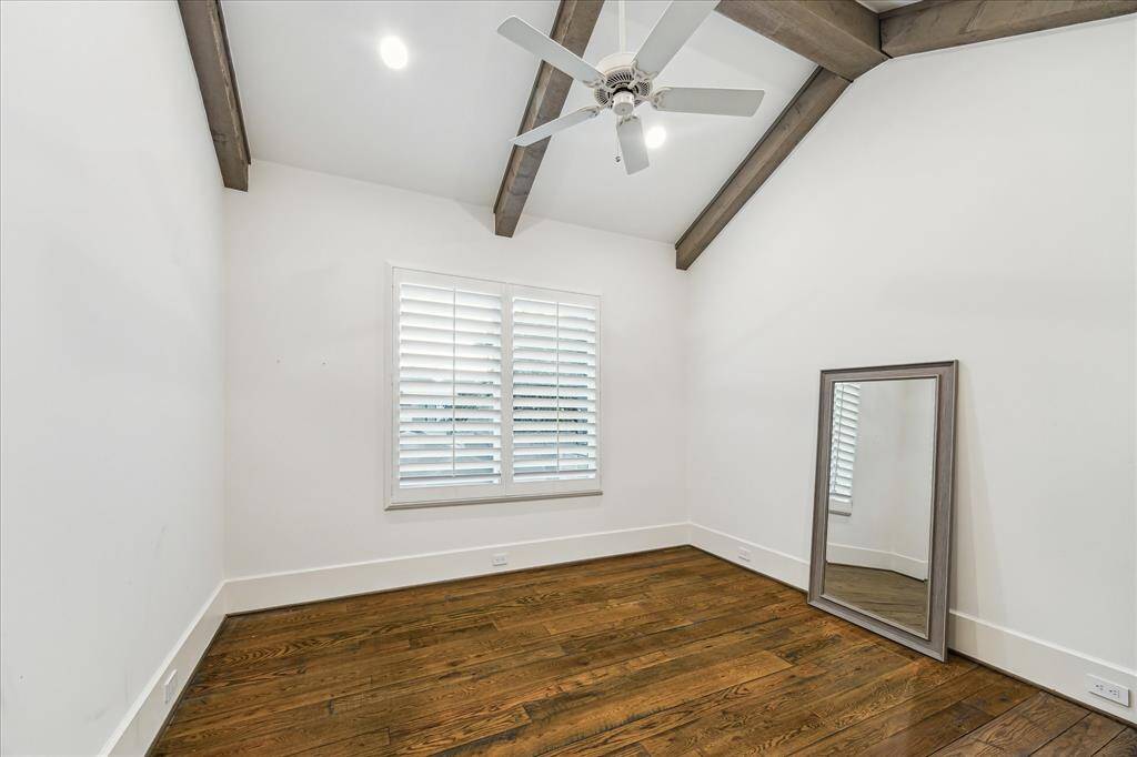 Vaulted ceilings and rustic beams define this flexible space—perfect as a bedroom, office, or playroom.