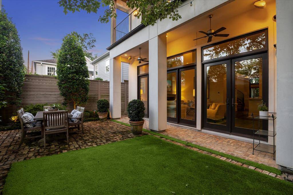 Charming brick patio with covered outdoor living and dining space—easily accessible from the main living room.