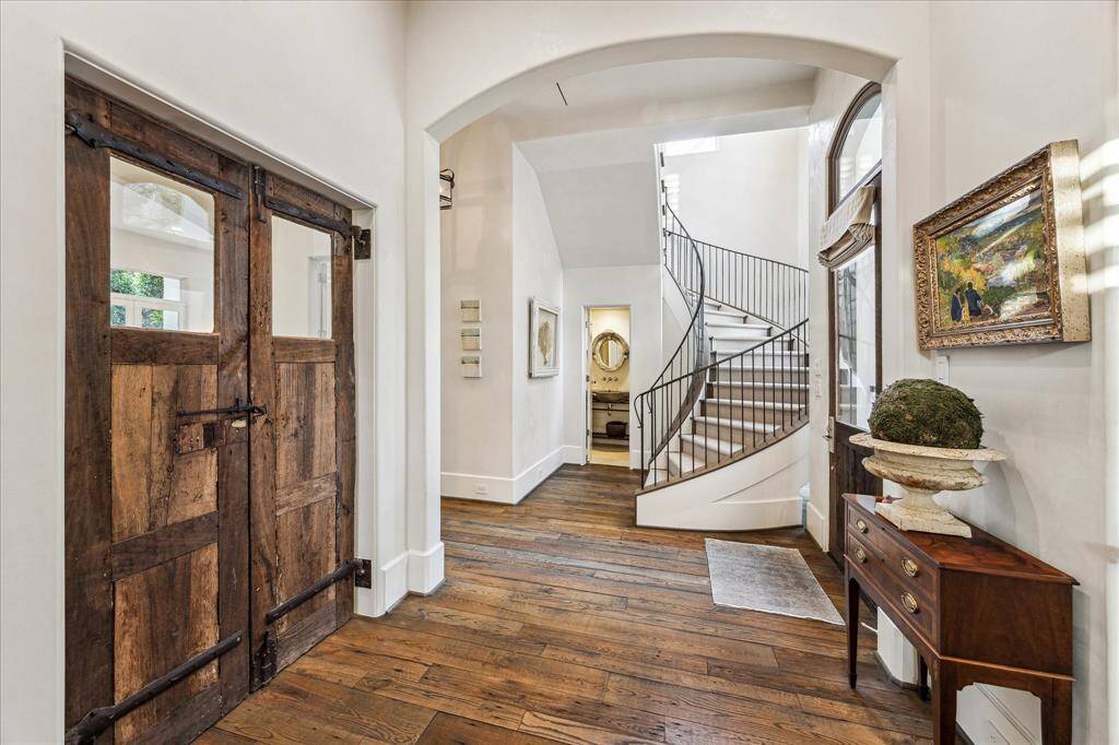 Entry hall with reclaimed barnwood floors, and 200-year-old custom barn doors.
