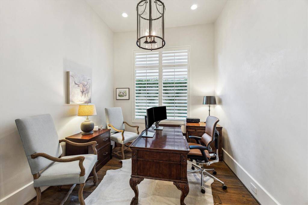 Private office with Venetian plaster walls, reclaimed wood floors, and plantation shutters.