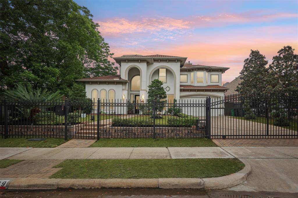 The exterior boasts a modern design with large arched windows and well-maintained landscaping, providing great curb appeal.