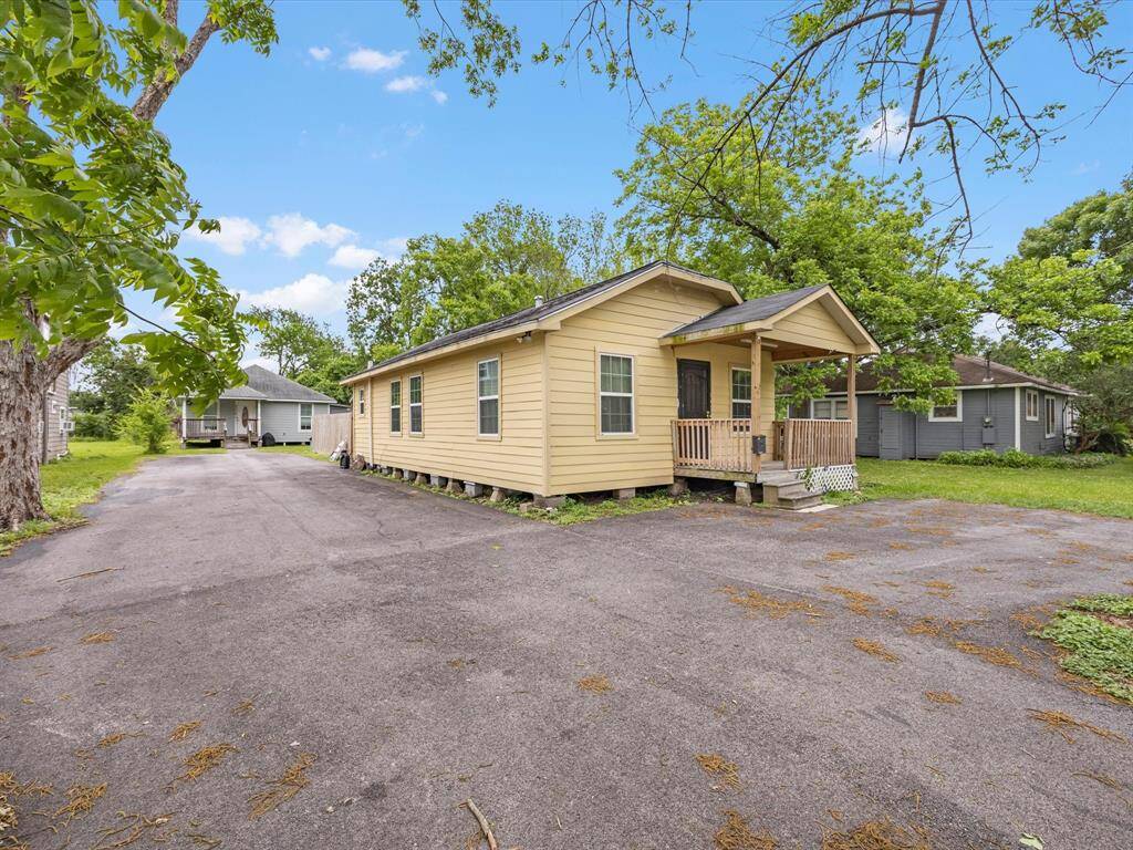 Unattached single-story dwellings with a welcoming front porch, set on a spacious lot with ample driveway parking. Surrounded by trees, it offers a cozy, private feel in a quiet neighborhood.