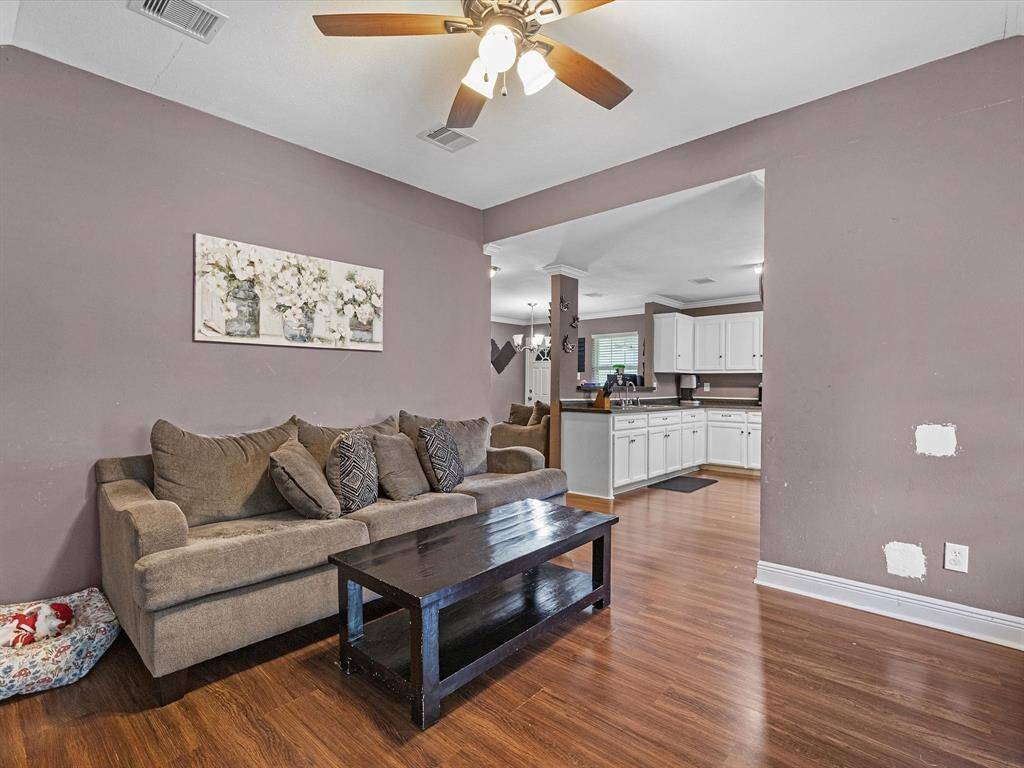 This photo features living room seamlessly connected to the kitchen.