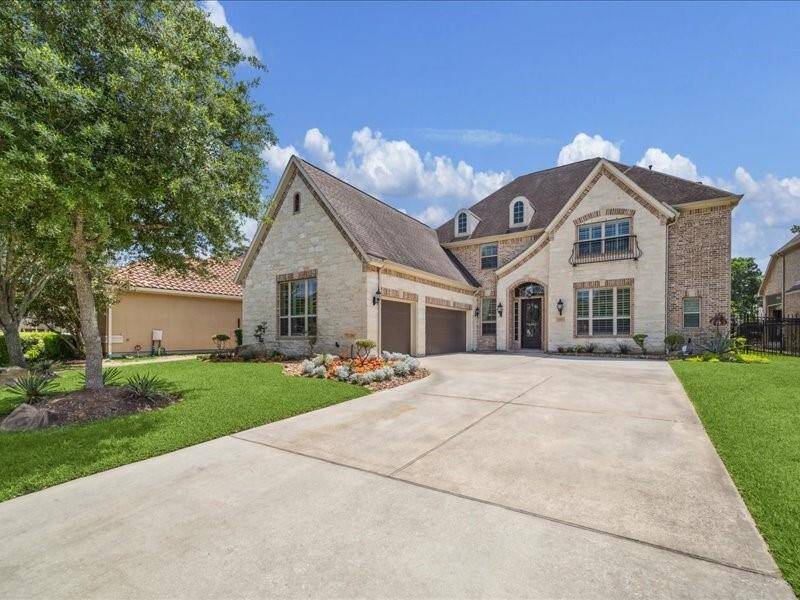 Beautiful Curb appeal with a 3 car garage, double car driveway, lovely stone and brick exterior. The 3 car garage has epoxy floors installed in 2024 along with new garage door openers.