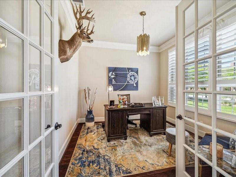 The private office is located up front with large windows to bring the outdoors in.  Beautiful shutters in here.