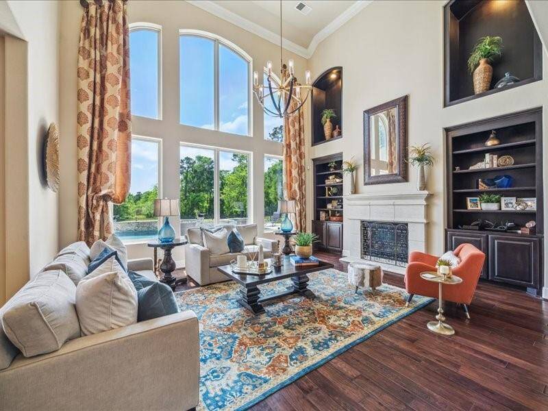 The custom bookshelves flank the fireplace and topped off with the touch of class lighted art niche.