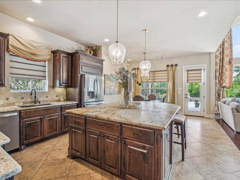 There is so much in this kitchen to enjoy.  From the custom cabintry to the sweeping gourmet countertops.  Look at the size of that island.  8Ft by 6Ft!!!!!