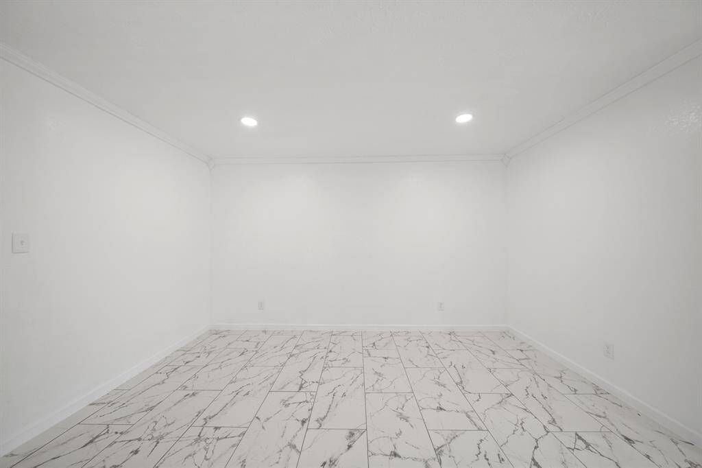 This addition can accommodate a dining table and has beautiful marble floors.