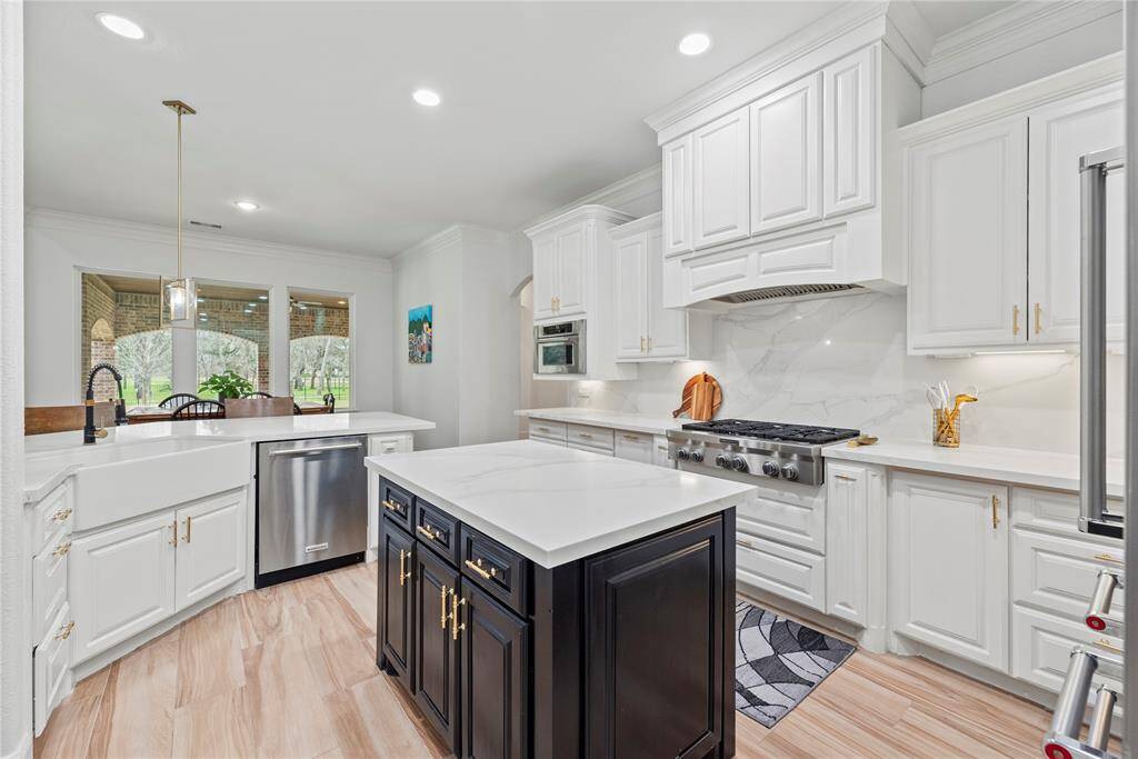 The sprawling center island serves as a versatile centerpiece, providing additional workspace and storage.