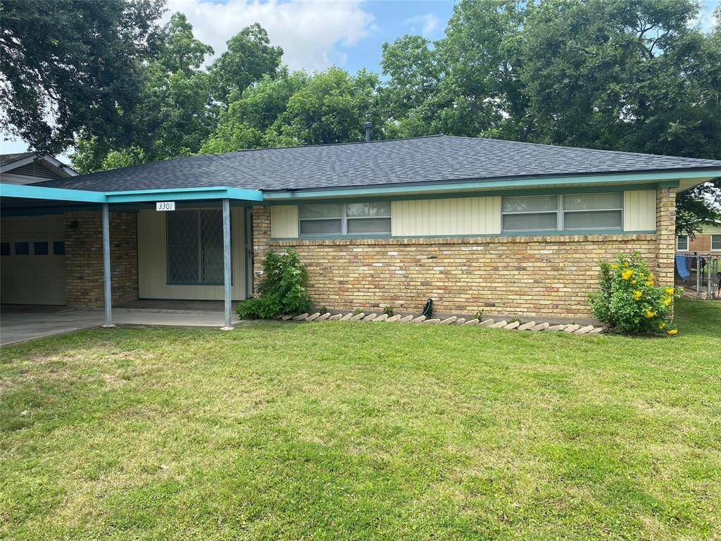 quiet neighborhood. brick front of house with 2-car carport