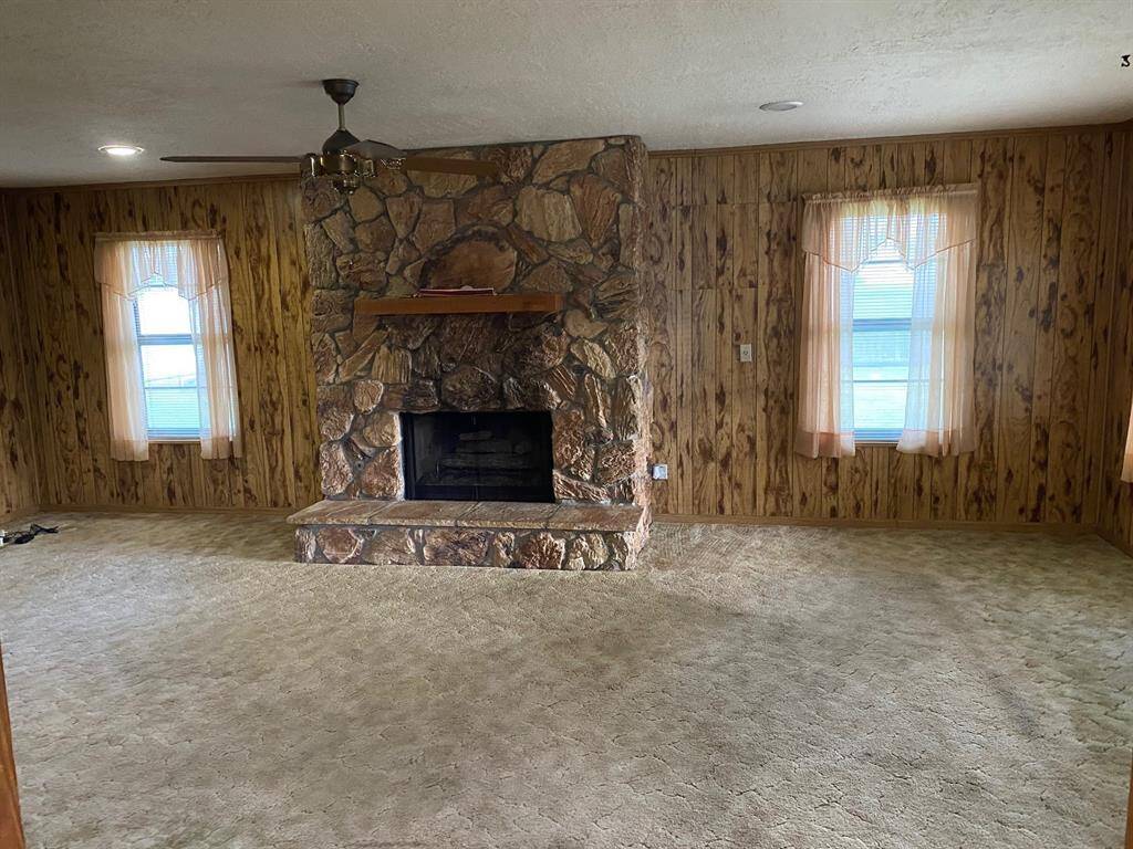 large den with views into backyard and back patio