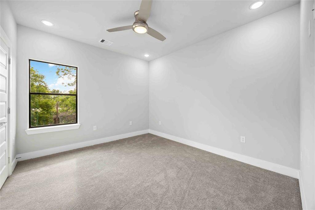Versatile second bedroom bathed in natural light with generous closet space and soothing color palette - ideal for guests or productive home workspace