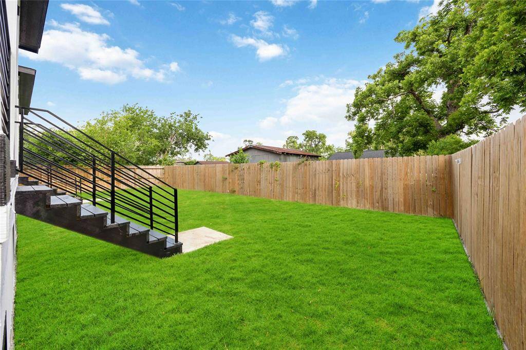 Enchanting secluded backyard oasis featuring intimate patio space perfect for morning coffee or evening gatherings, and thoughtful lightingc creating a magical atmosphere