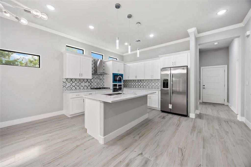 Contemporary gourmet kitchen unfolds into entertaining space