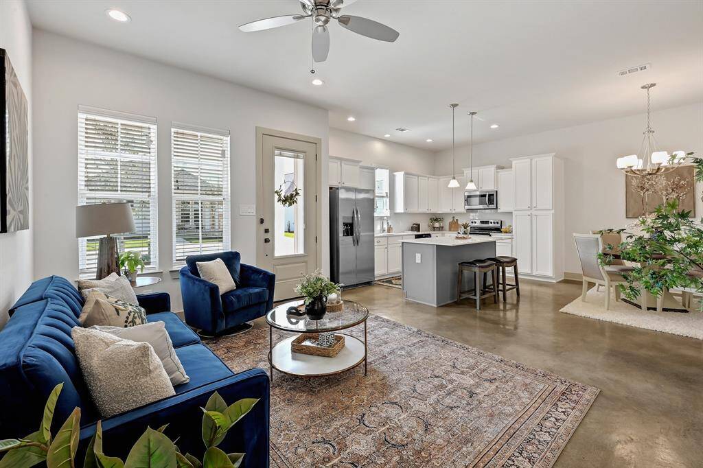 Spacious living area! Soaring ceilings, stained concrete floors, stainless steel appliances!Model Home.