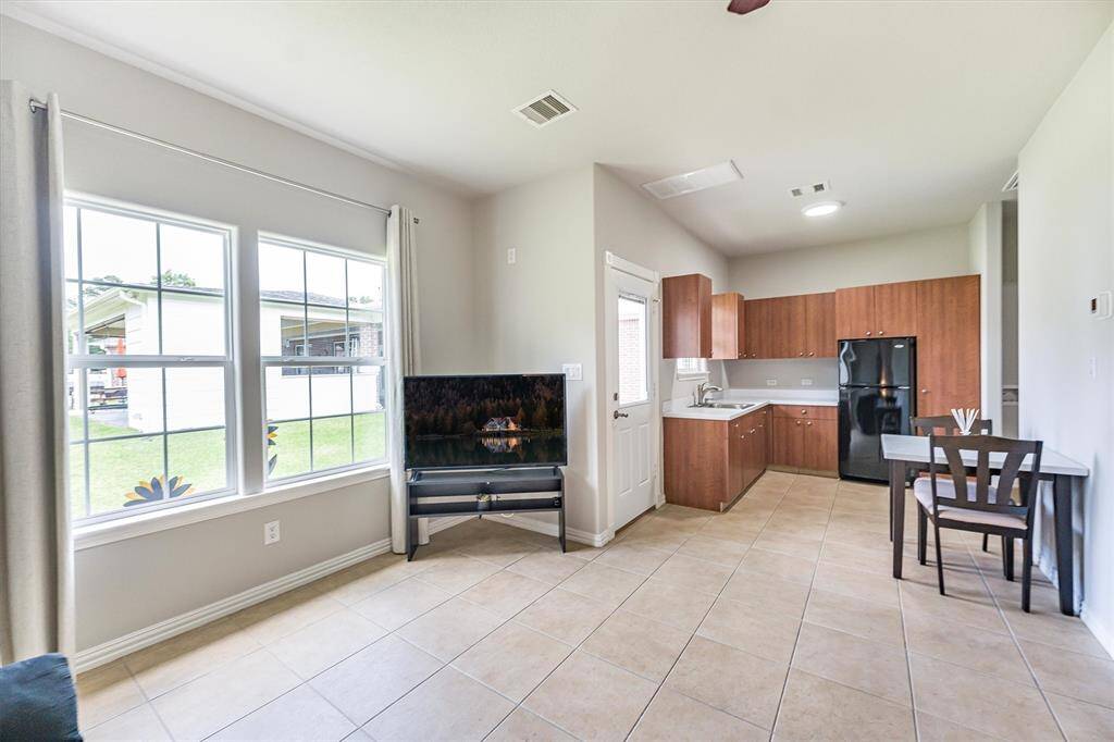 Another view of the guest home that includes kitchen cabinets.