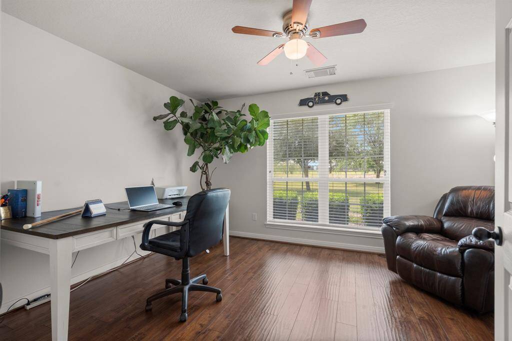 This versatile room can easily serve as a productive home office or a comfortable den. Enjoy the natural light and the convenience of a ceiling fan.