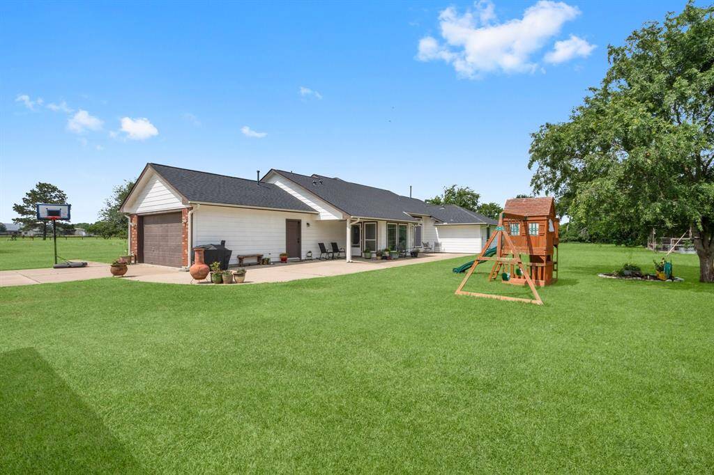 Expansive backyard with a covered patio and plenty of room for outdoor enjoyment.