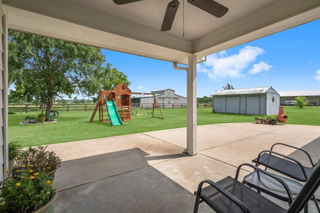 Extend your living space outdoors with this covered patio, providing a comfortable area to relax and enjoy the backyard in any weather.