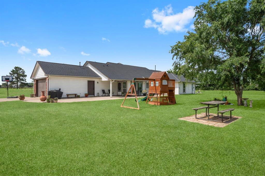 Perfect for families, this property boasts a huge backyard complete with a playset and a picnic table, creating a wonderful environment for outdoor fun and making memories.