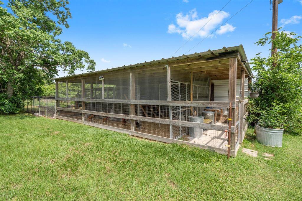 This chicken coop features a covered run and enclosed shelter, providing a safe and protected environment for your chickens.
