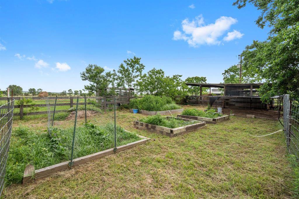 Enjoy the opportunity to grow your own fresh produce in this dedicated fenced garden with several raised planting beds.