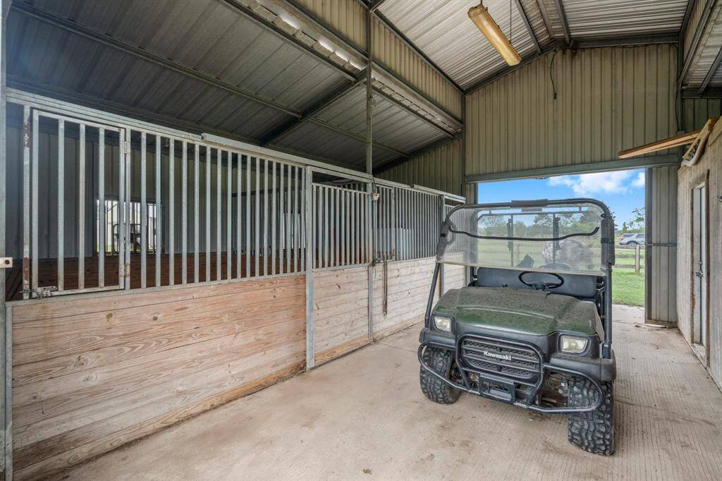 This property boasts a functional equestrian setup with horse stalls within the barn. The inclusion of a mule vehicle adds a significant layer of convenience for property owners.