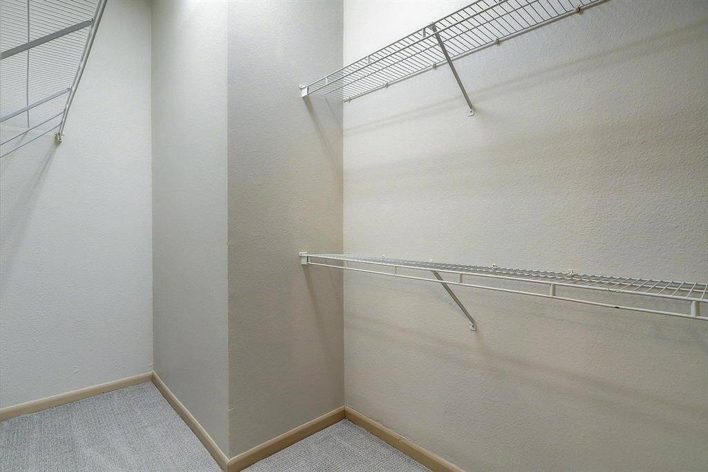 A large walk in closet is located just through the bathroom.