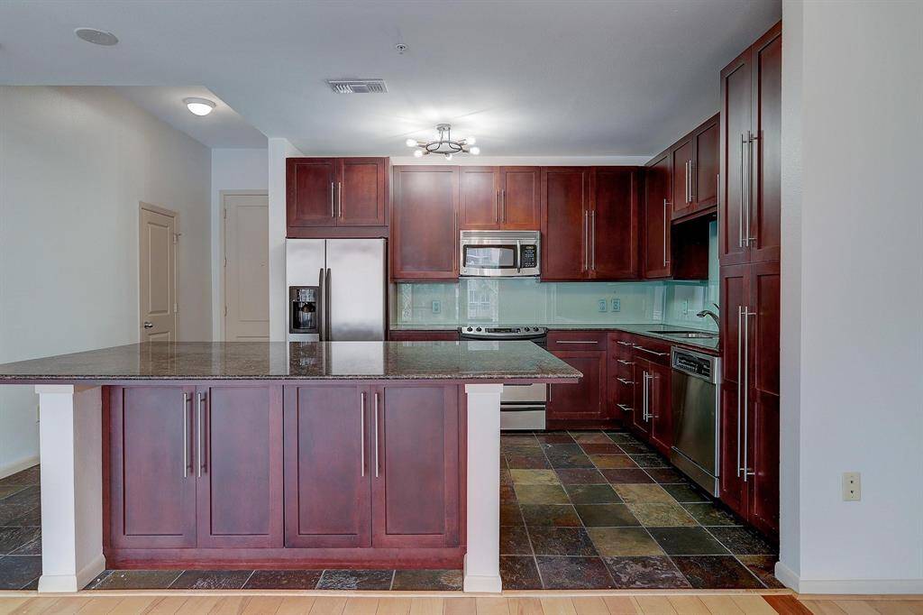 The expansive kitchen island has enough room to seat at least 3 people.