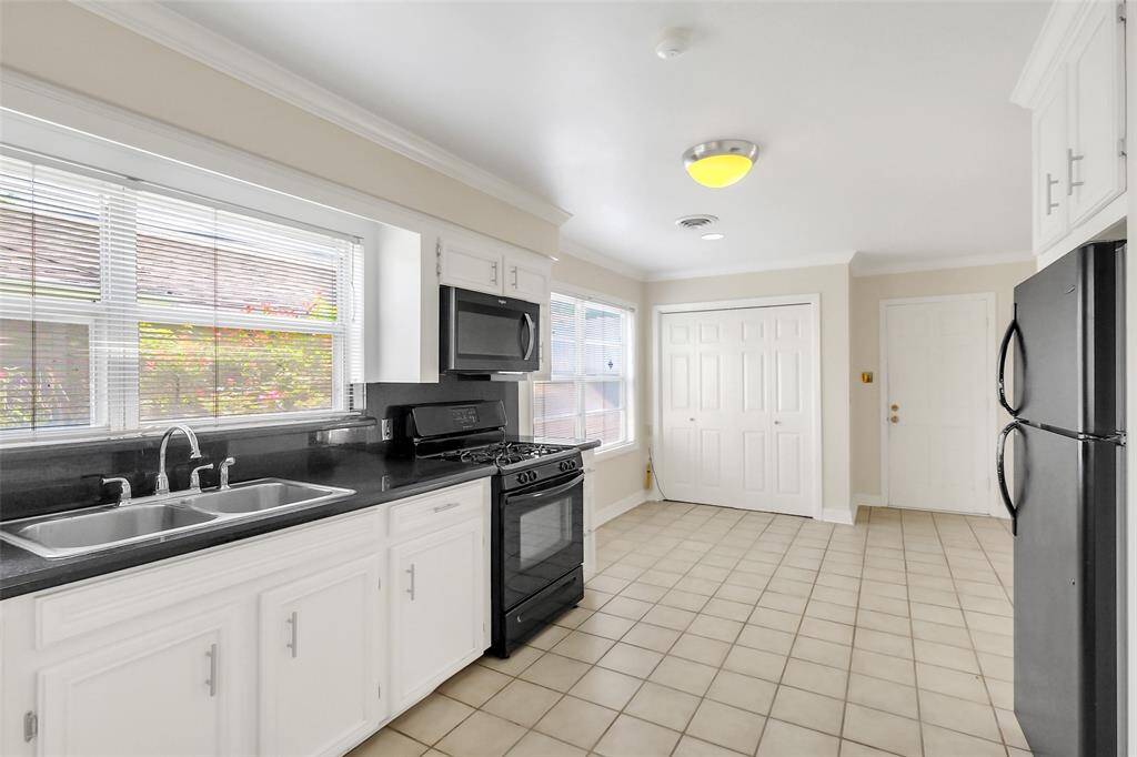 At the back of the kitchen is a breakfast area or informal dining.  Beyond that are the utilities available in the closet area.  Next to that is the back door to the home out to the outbuildings and yard areas.