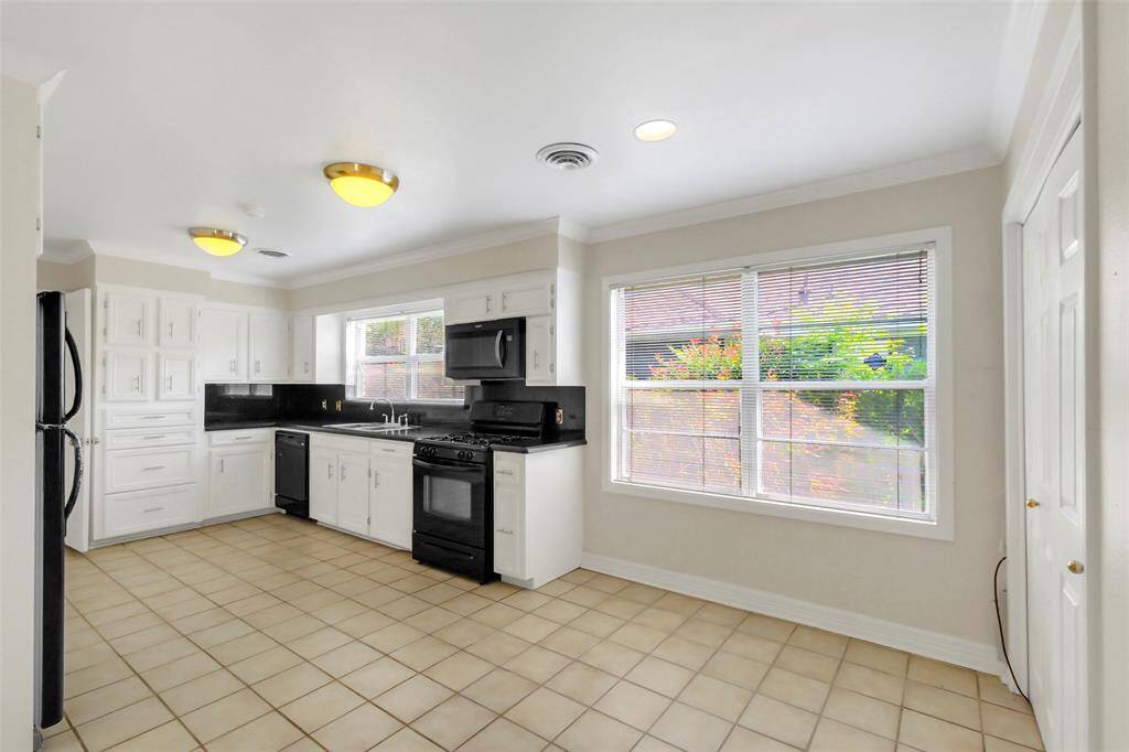 Another view of the kitchen area and breakfast area.  There is a lot of great natural light into these rooms and plenty of space for a potential kitchen expansion/remodel to taste.