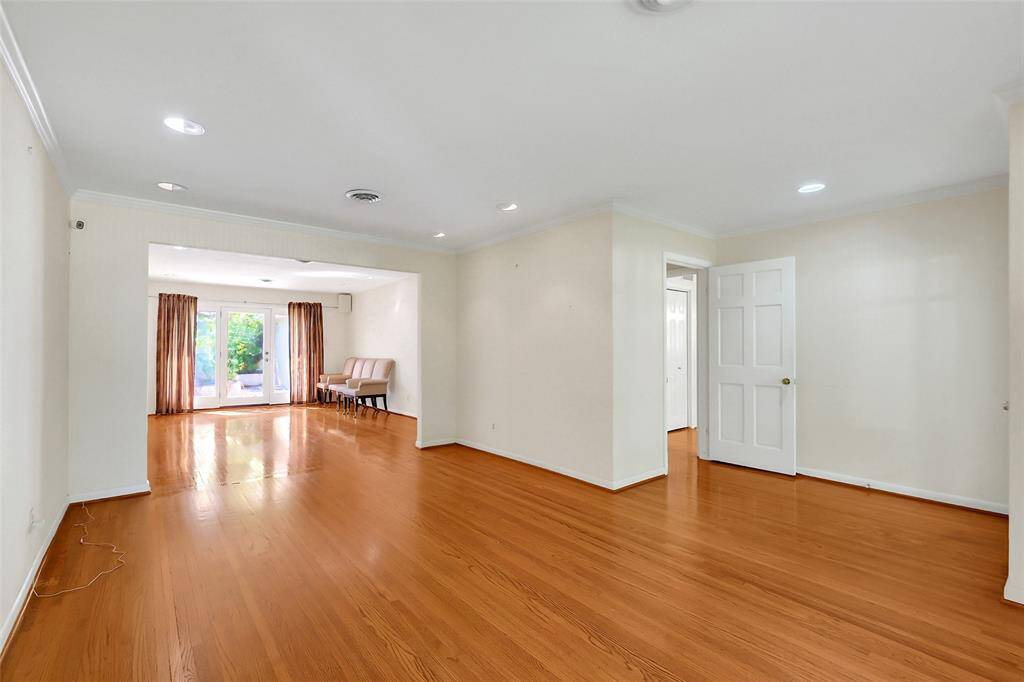 From the doorway to the dining room looking into the two joined living areas and entry.  Again, plenty of wall space for prized furnishings or art!