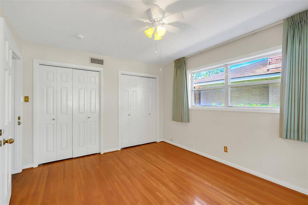 Here is the other view of the front bedroom showing two closets, doorway to the hall at left, and the great hardwood flooring.  Note: there is NO carpet in this home whatsoever.  It is all hard surface flooring, and most of it are the original hardwood floors.