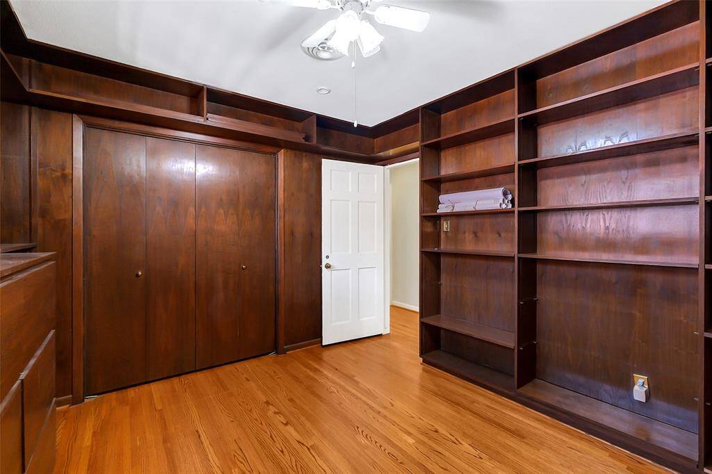 The door to this bedroom/study open to the hallway.  There is also a nicely sized closet.  Note the display shelving extends even over the doorways.