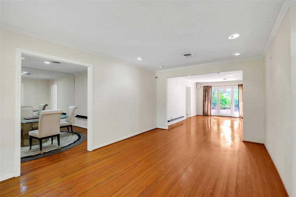 Here are the two living areas shown together.  To the left is the formal dining area.  In back of what could be the more formal living area is an almost equally sized den/family area which looks out to a rear patio area.
