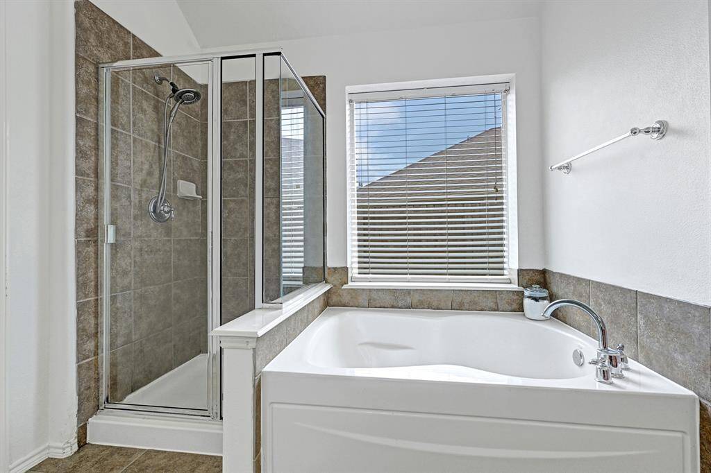 With a soaking tub and separate shower, this primary bath is a great place to relax and unwind.