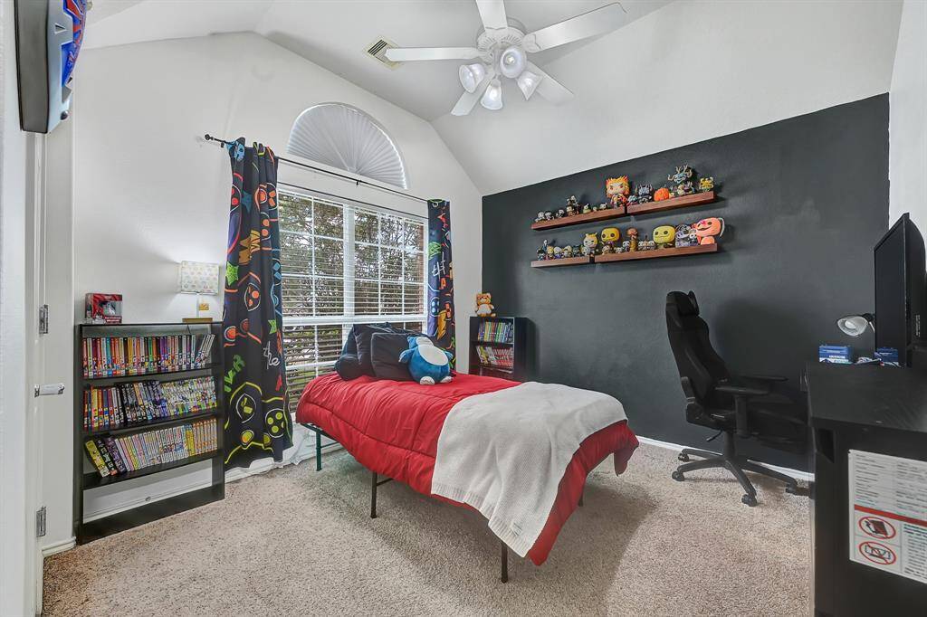 Secondary bedroom 1 with accent wall, and large window add interest to the room.