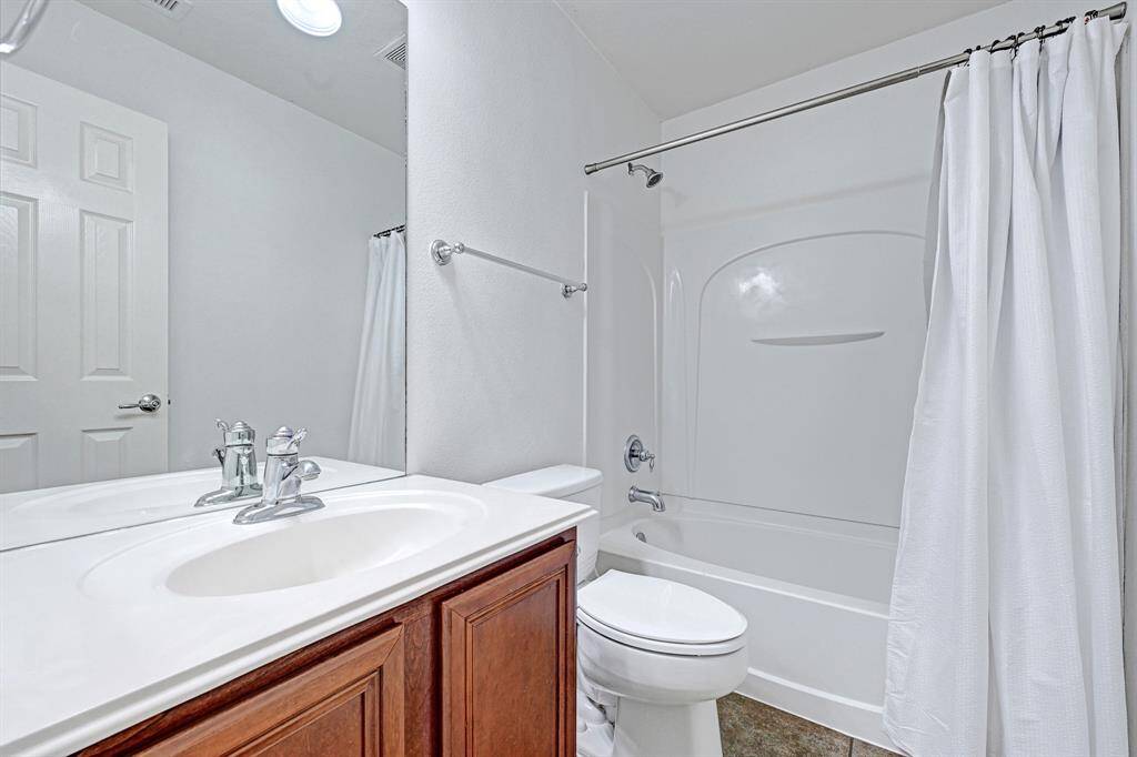 Hall bath with tub/shower combo.