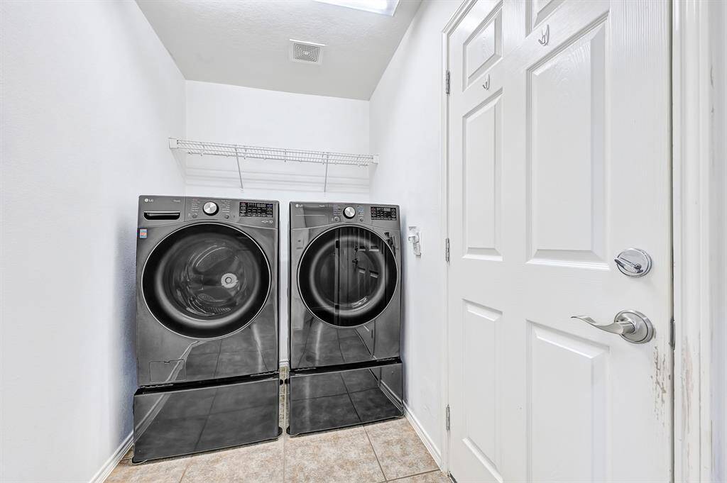 The indoor laundry room has shelving to store your cleaning supplies.