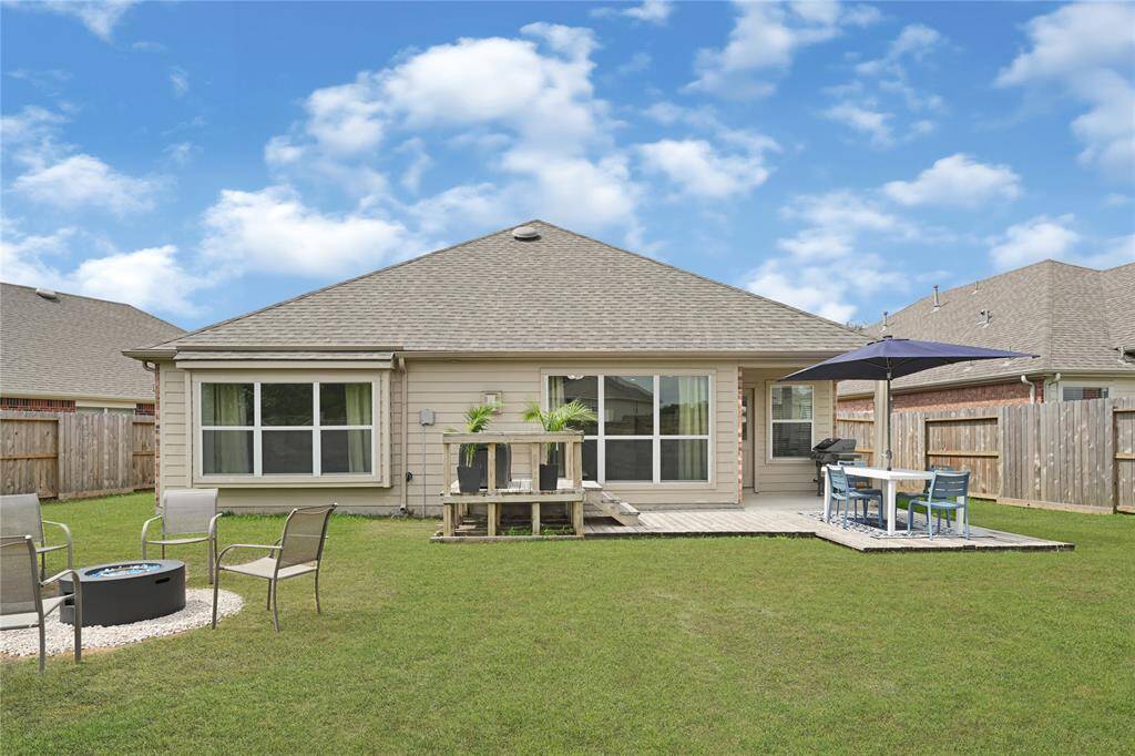 Just look at this fantastic yard with options for entertainment and fun! There's a covered patio, space for outdoor dining, plants and gardening/storage, another gathering area, and plenty of room to spare! **Grass edited**