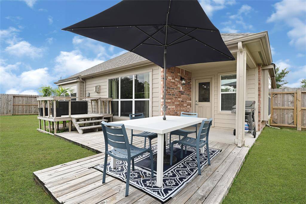 The wood deck is great for dining. **Grass edited**