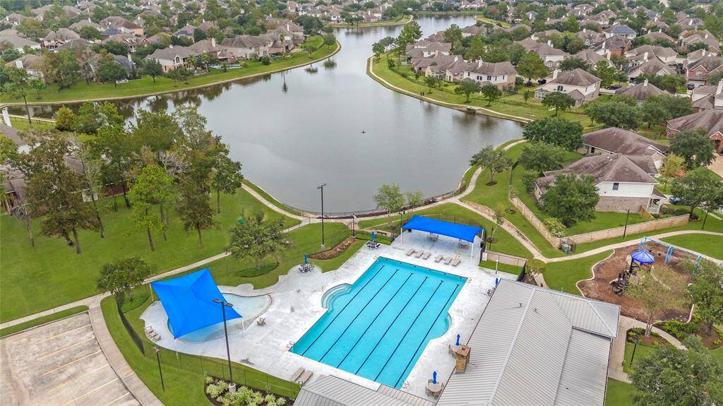 Community pool, playground, and lake view.