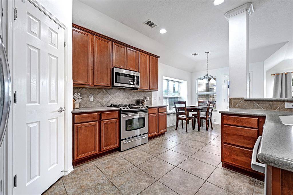 Alternate view of kitchen looking towards the breakfast table area.