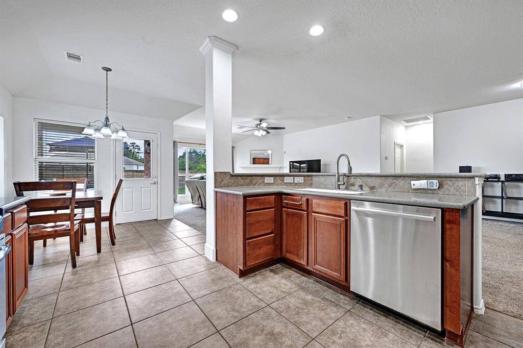 The kitchen also features a counter-height bar area opposite the sink.