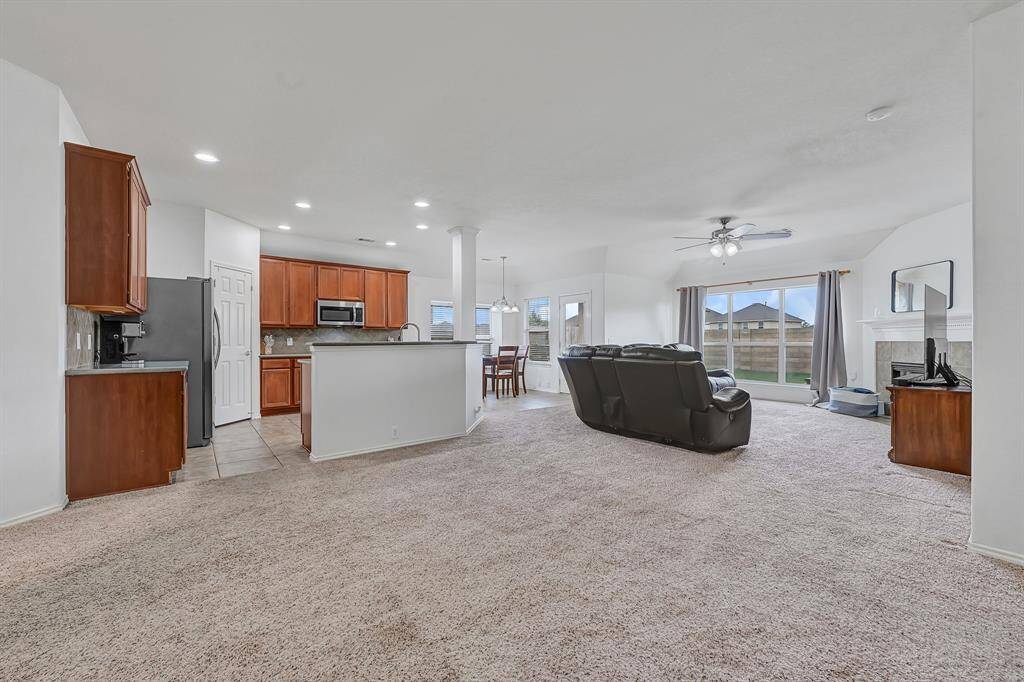 The open concept living area features views into the kitchen, living room, and extra room to use how you choose. Perfect for entertaining or a relaxing night in.
