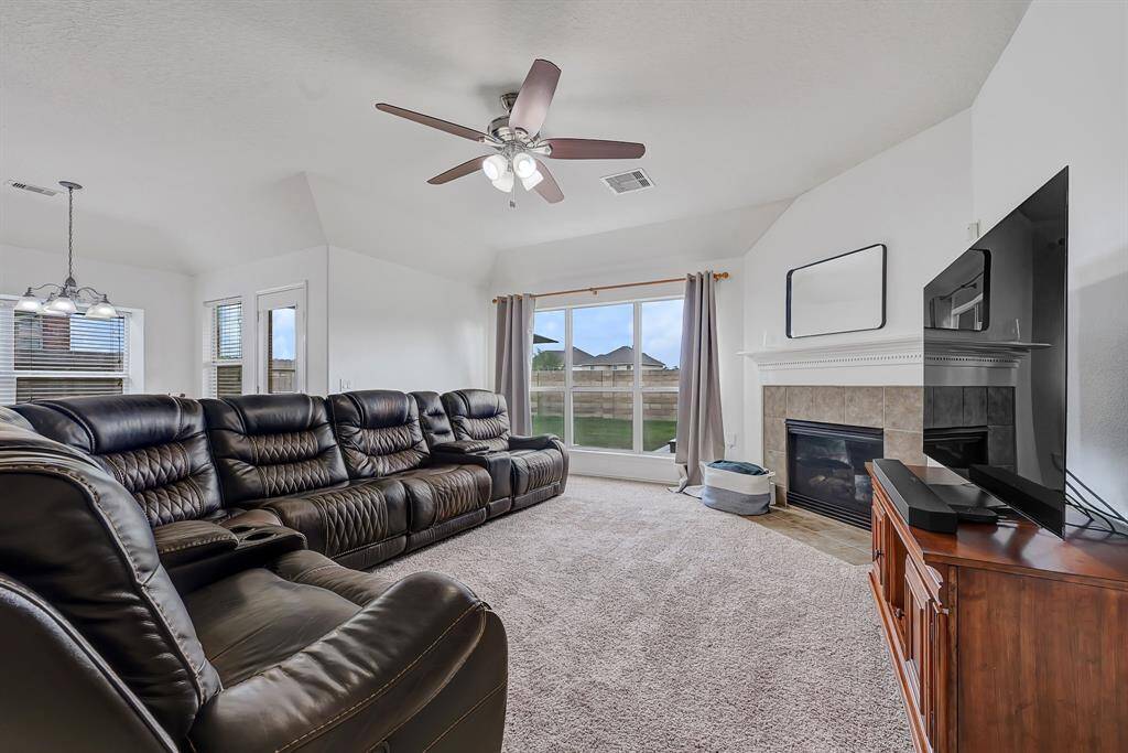 Large furniture welcome here! This spacious living room easily accommodates this large sectional sofa with room to spare while the large window allows ample natural light to fill the room.