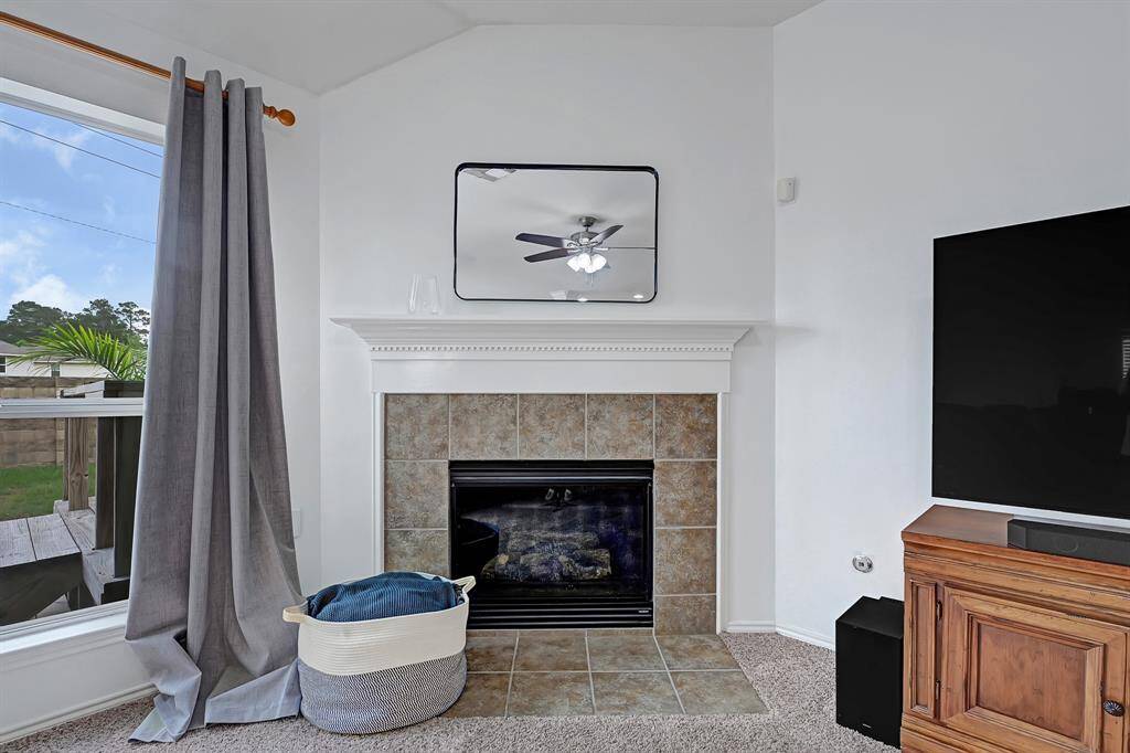 The focal point of this large living room is the fireplace, adding just the right touch of architectural interest with the angled ceiling.