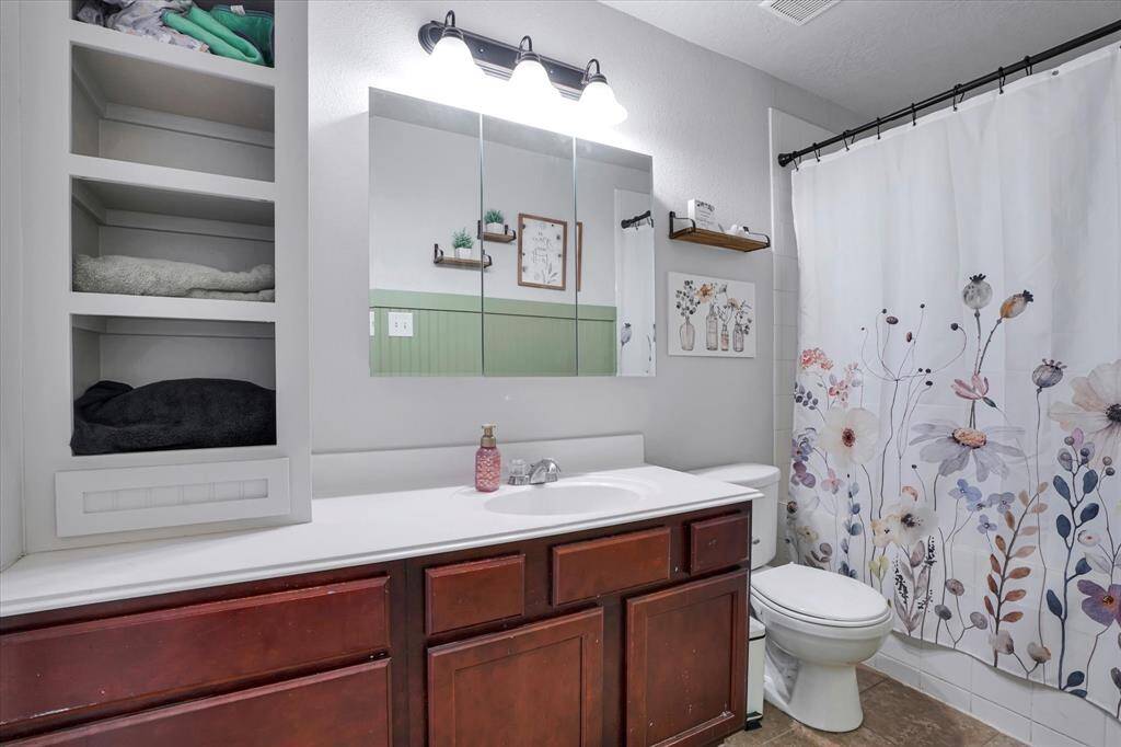 Ensuite bath with a tub/shower combo, large vanity, and plenty of space to unwind