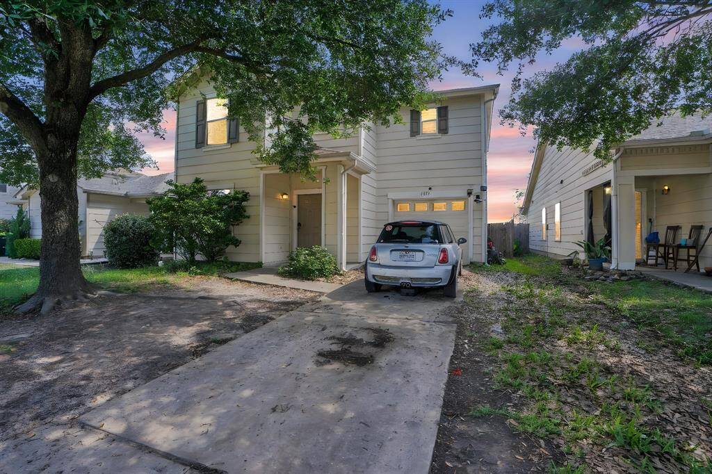 Extended driveway fits two cars comfortably off the street, with additional parking available in the attached one-car garage