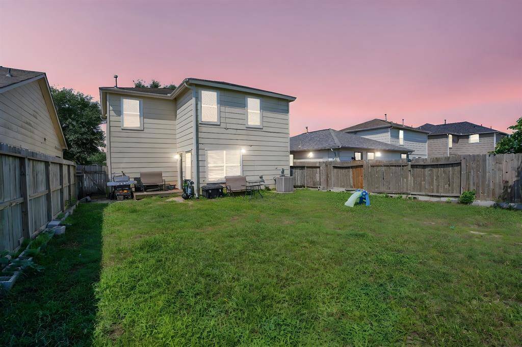 Fully fenced backyard with no rear neighbors, offering added privacy, room to play, and peaceful Houston sunsets to end your day.